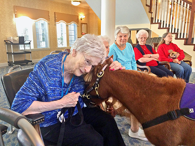 This little pony gets a big hug from Claudine Nichols, a resident at Imboden Creek Living Center, Decatur, Illinois. (DTN/The Progressive Farmer photo by Pamela Smith)